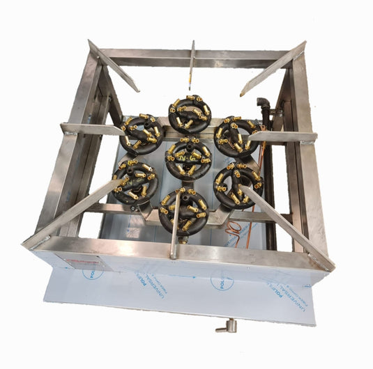 A stainless steel gas burner assembly with six black and brass burner heads, shown from a top-down perspective on a white background.